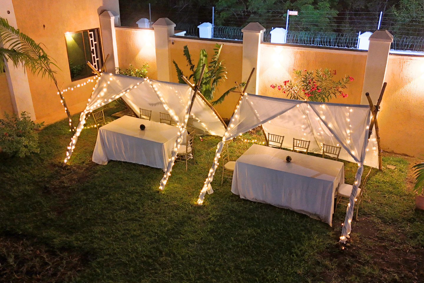 Illuminated outdoor dining tents prepared for an evening event