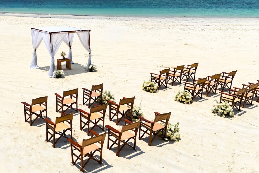 Wooden event chairs arranged for a wedding ceremony on Diani Beach