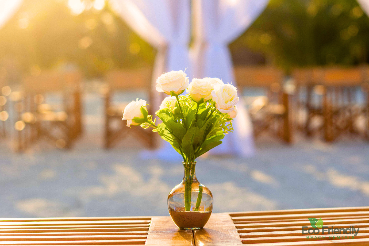White floral arrangement glowing in the evening light at a coastal event