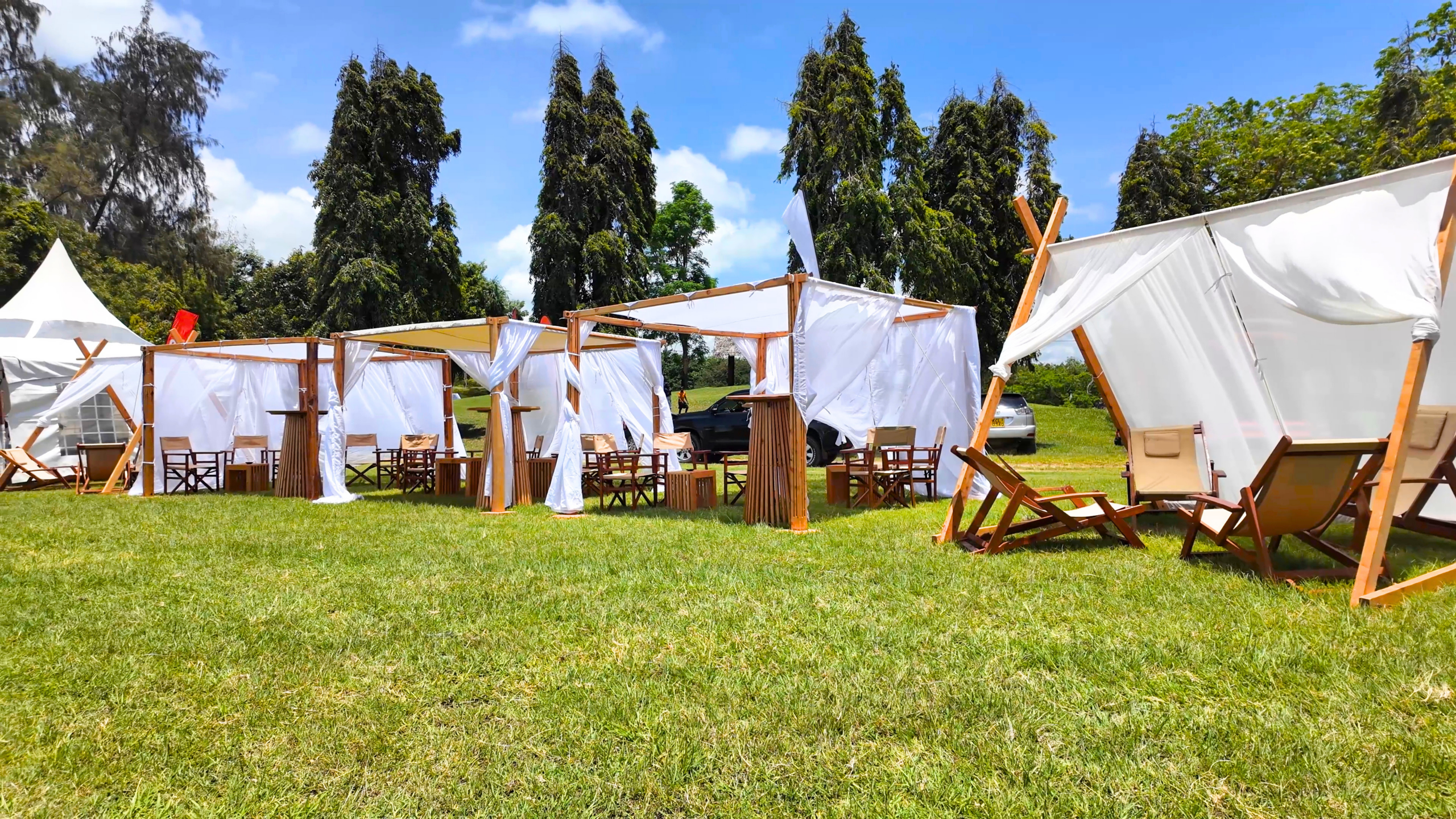 Row of wooden event canopies on the lawn at the Diani Charity Goat Derby